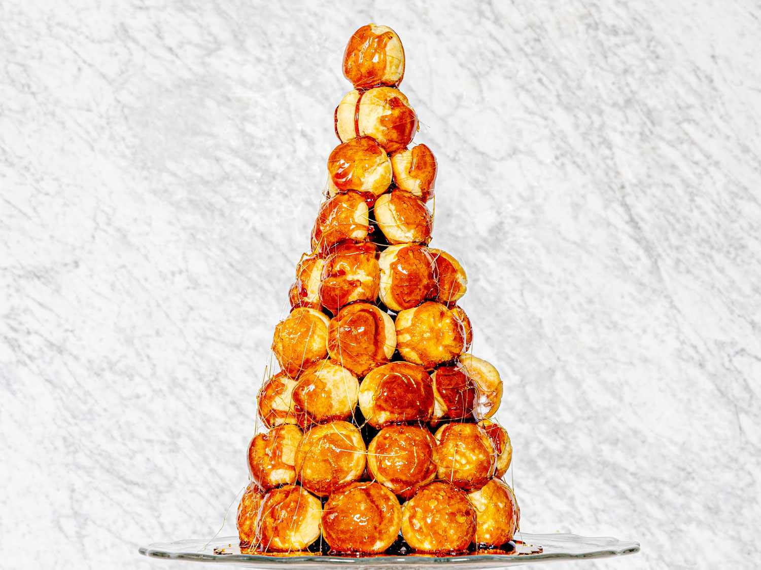 A crouquemboche, which is a tower of cream-filled choux pastry puffs which are glued together with caramel and then draped in thin strands of hardened sugar.