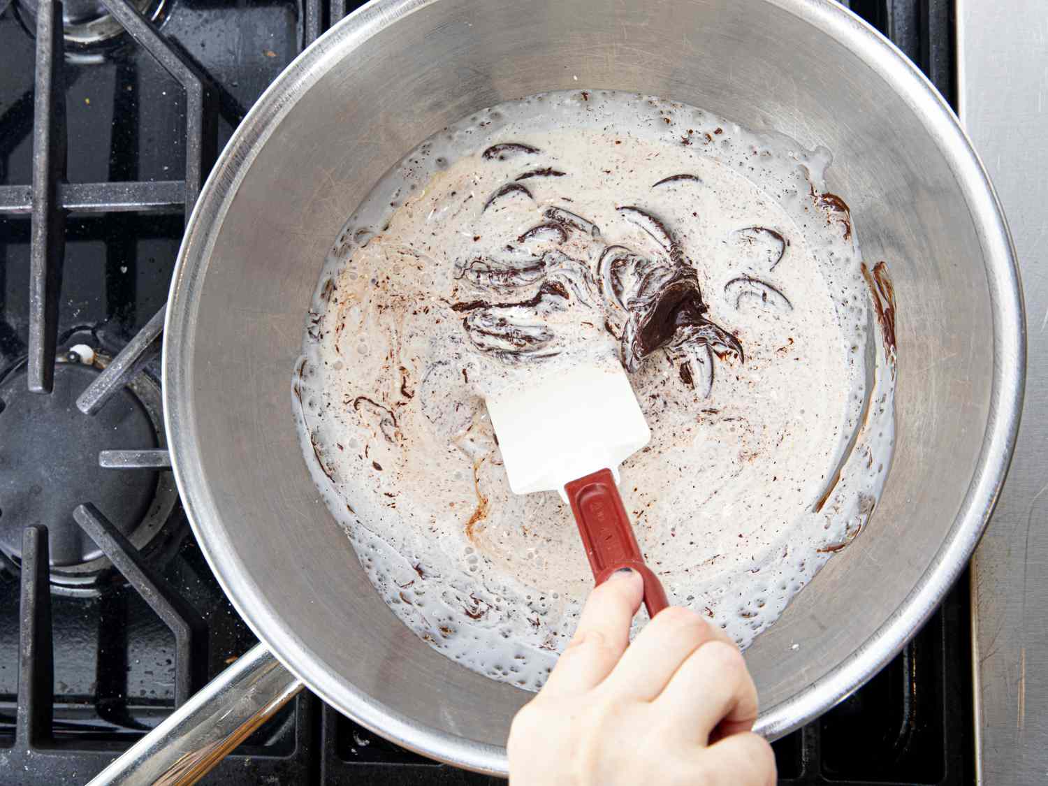 Mixing chocolate in a bowl on a saucepan