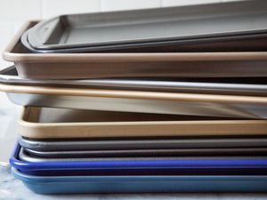 nonstick sheet pans stacked on each other on a marble countertop