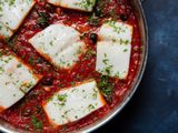 Closeup overhead of a skillet of baccalÃ  alla napoletana.