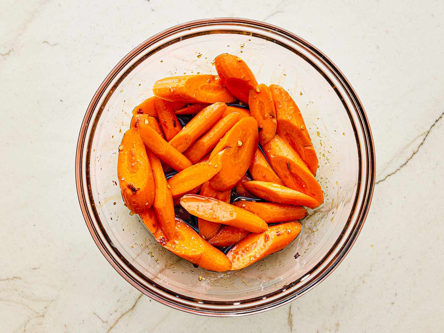 Overhead view of carrots marinating.