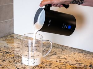 pouring oat milk from the miroco frother