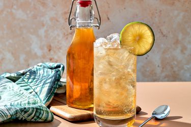 DIY tonic water in a bottle, a glass with gin and tonic in the foreground