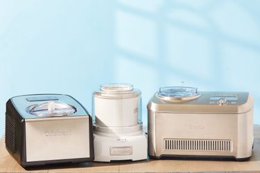 three ice cream makers on a wooden surface