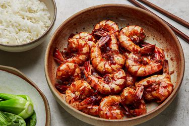 Overhead view of braised shrimp with a side of rice and bok choy