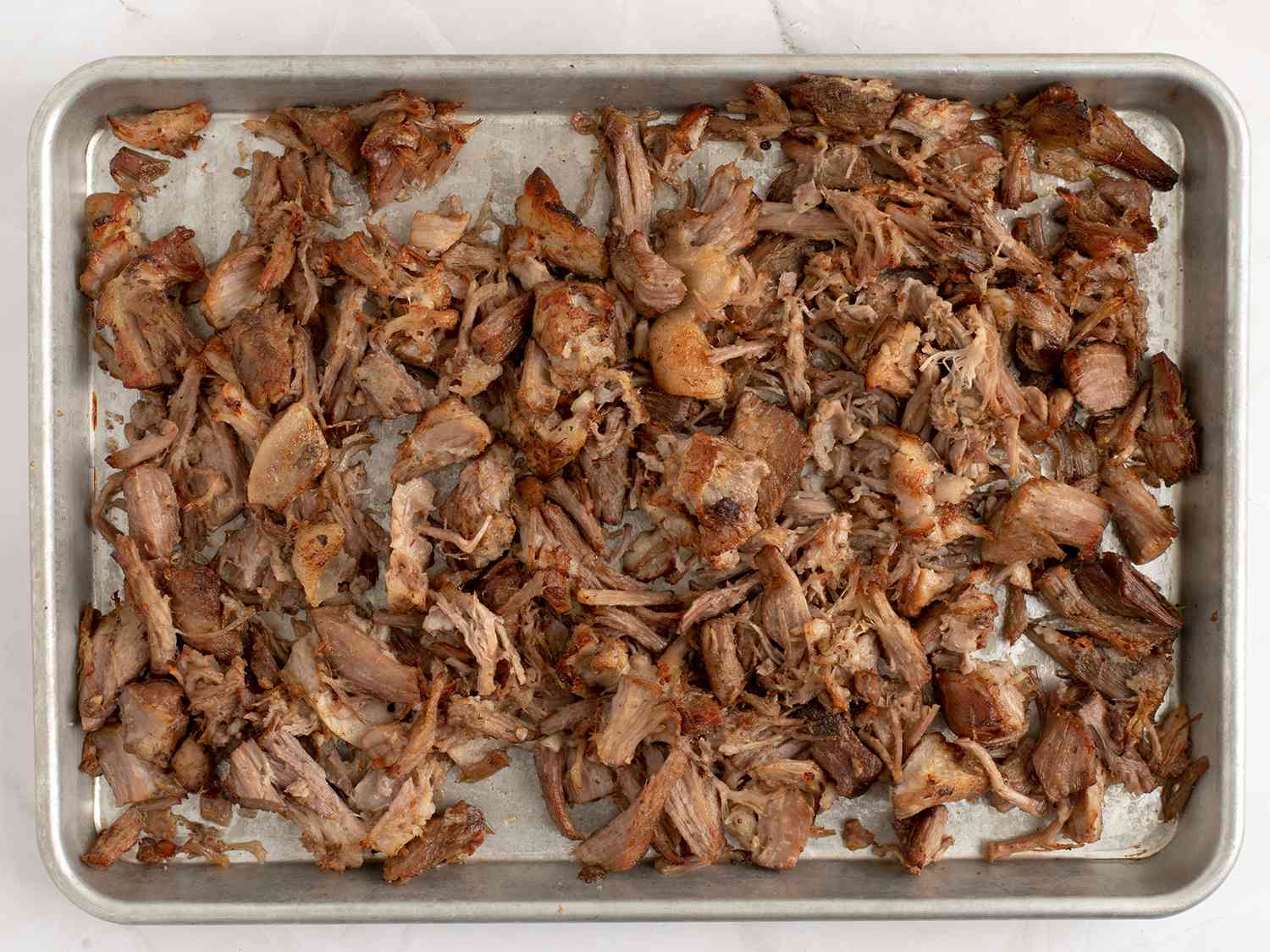 Broiled pork pieces on a baking sheet