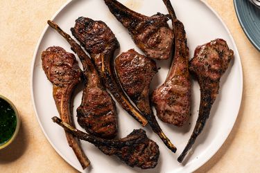 Grilled lamb ribs on a white ceramic plate.