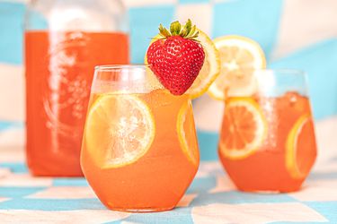 Strawberry lemonade in two glasses and a pitcher