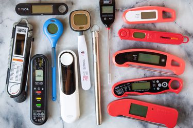 a bunch of instant-read thermometers on a marble countertop