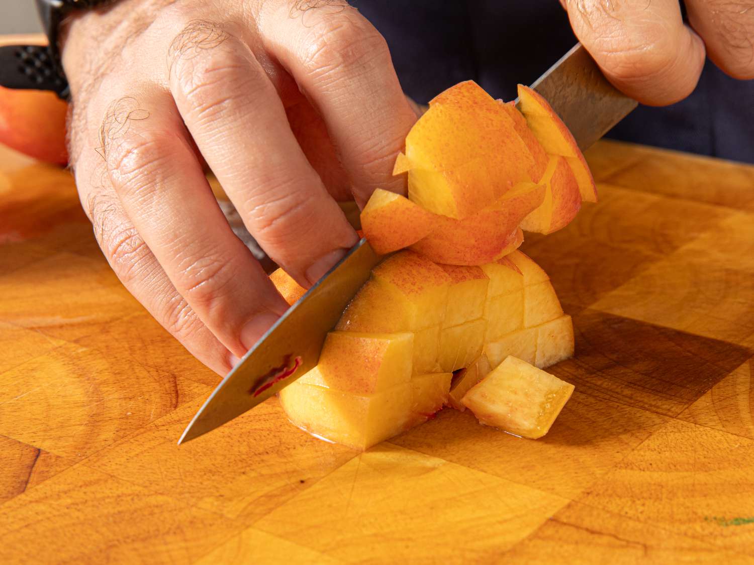 Side view of dicing peaches