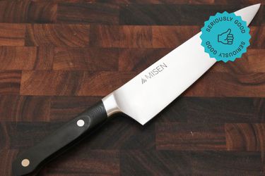 The Misen Chef's Knife on a wooden cutting board