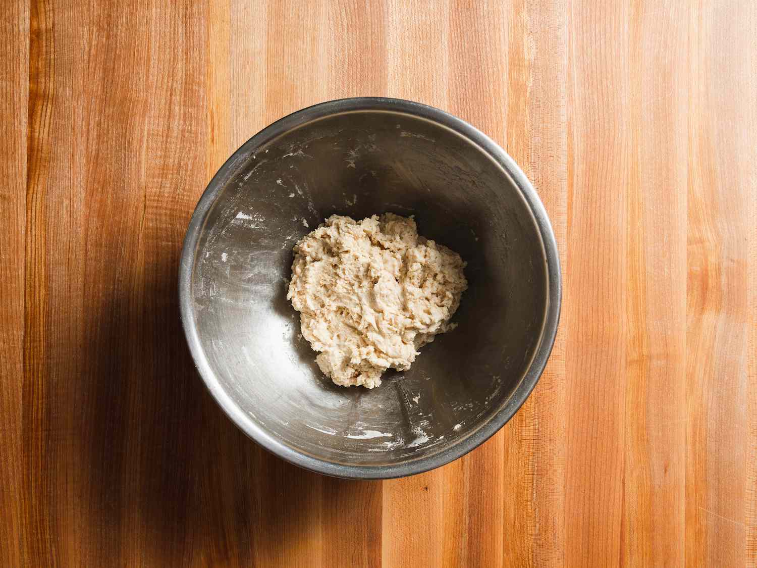 Lavash dough in a bowl, mixed together until no dry flour remains.