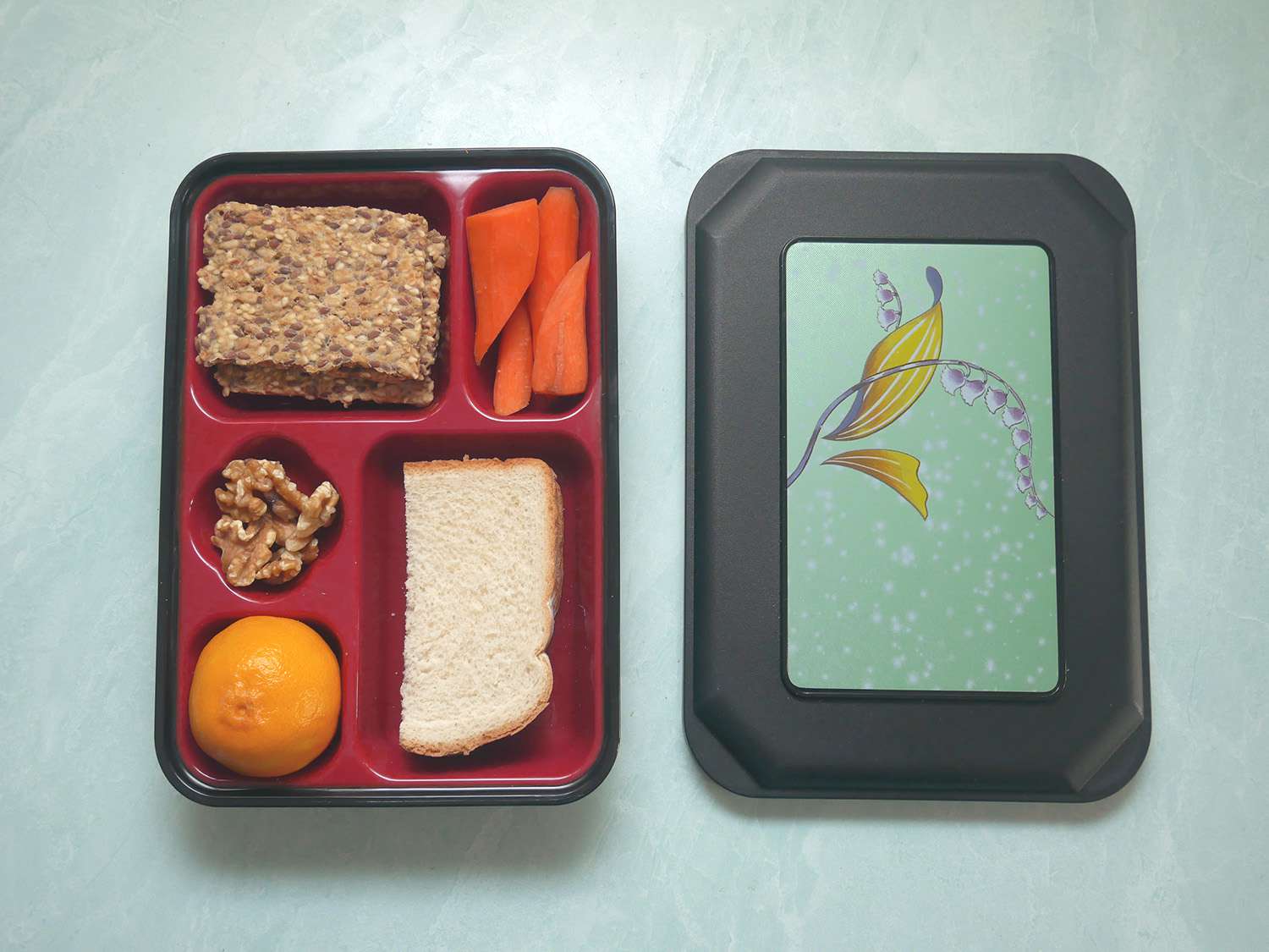 a traditional style bento box with food inside the compartments.