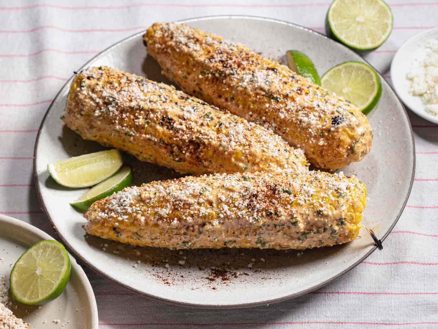 side angle of elotes surrounded by sliced limes