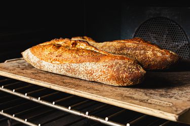 Loaves on a baking stone in an oven