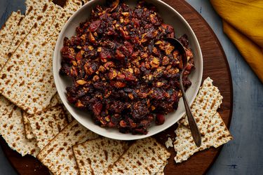 Overhead view of charoset in a bowl surrounded by matzah crackers