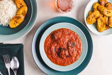 Overhead view of beef stew served with plantains and rice