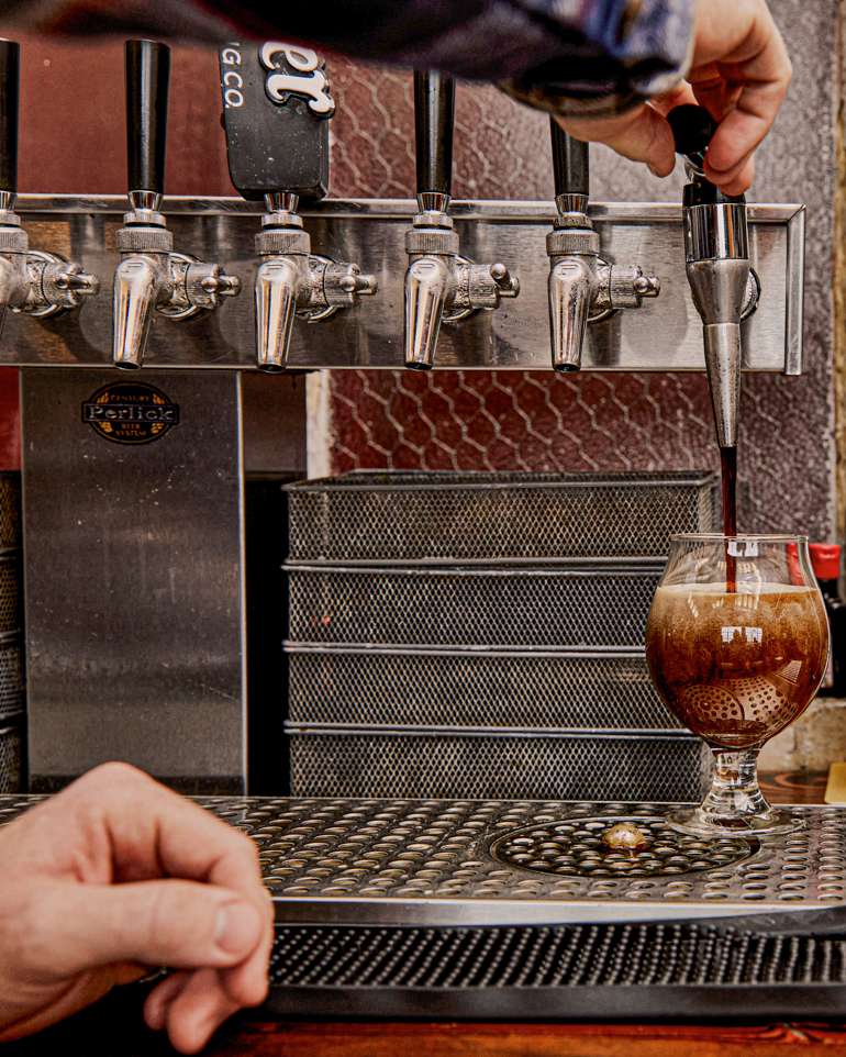 Sideview of a draft beer being poured at Dorchester Brewing