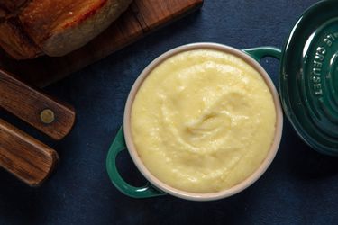 A small dish filled with smooth and buttery pommes puree.